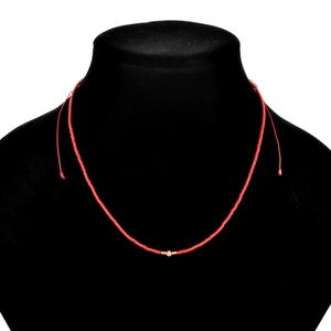 Handmade minimalist red seed bead necklace with pink and gold accents on a black bust stand