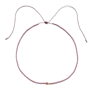 Detail of beaded necklace with purple square beads, gold spacers and adjustable cord