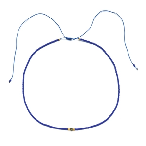 Detail of adjustable blue bead necklace with gold accents and malachite-style stone