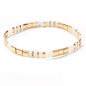 Close-up of Tila bead bracelet with alternating gold and white rectangular geometric tiles