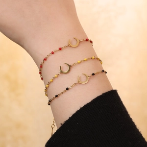 Detailed close-up of a three-piece gold crescent moon bracelet set with colorful beads