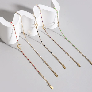 Detail of five colorful beaded moon bracelets in gold-plated stainless steel with s.steel tag