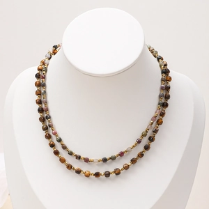Detail of layered bohemian necklace with faceted natural stone beads and gold spacers
