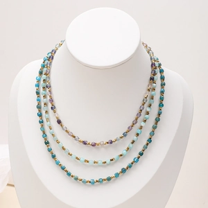 Detail view of triple-layered necklace with colorful natural stone beads and gold accents