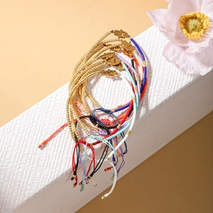 Set of colorful hand-woven Hamsa bracelets with gold-plated beads and adjustable cords