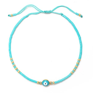 Pulsera de cuentas turquesa ojo turco con cordón ajustable y detalles en color dorado