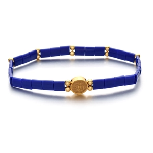 Bohemian Tila bead bracelet in deep blue and gold with a St. Benedict medal charm