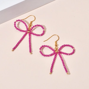 Handmade bohemian style magenta beaded bow earrings with golden hooks for women