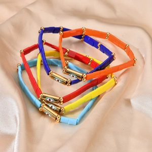 Bohemian colorful enamel bead bracelets set with golden evil eye charms on satin
