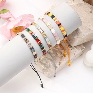 Bohemian MIYUKI Tila bead bracelets set with adjustable woven cords on display