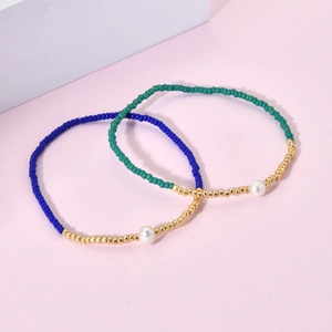 Set of two Miyuki bead bracelets in navy and green with a central single white pearl