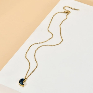 Minimalist gold moon pendant necklace with blue druzy crystal on white stone