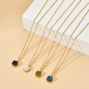 Detail view of four gold-plated necklaces with colorful square druzy stone pendants