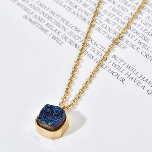 Macro shot of square blue druzy crystal pendant with gold-plated stainless steel chain
