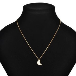 Elegant gold crescent moon pendant necklace with white inlay displayed on black velvet stand