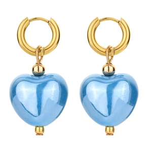 Detailed view of sky blue ceramic heart pendant on gold metal hoop earrings