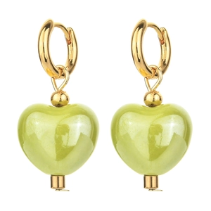 Detailed macro view of light green ceramic heart pendants on gold hoop earrings