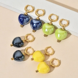 Detailed display of colorful heart ceramic pendant earrings in blue, green, black and yellow