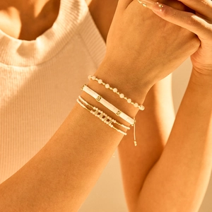 Bohemian 4-piece stackable bracelet set with Tila beads and crystals on a female wrist