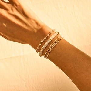 Close-up of Bohemian Tila bead bracelets with gold accents and crystals worn on wrist