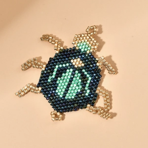 Handmade MIYUKI bead beetle charm in iridescent gold, green and blue for DIY jewelry