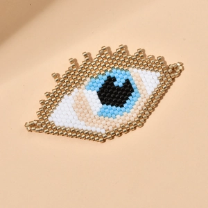 Handmade MIYUKI bead Evil Eye brooch accessory with intricate eyelash fringe detail