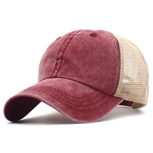 Detail view of burgundy cotton and cream mesh trucker hat with reinforced brim stitching
