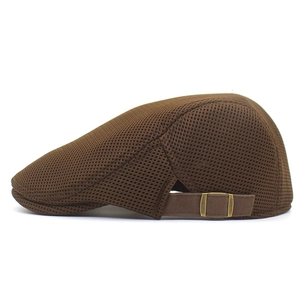 Detail view of the breathable dark brown mesh fabric and bronze side buckle on the cap
