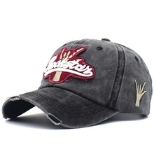 Close-up of Rockstar embroidery and distressed details on a vintage grey baseball cap