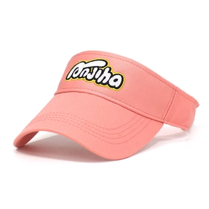 Detail of pink cotton sun visor featuring premium letter embroidery and reinforced brim