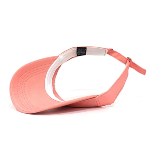 Detail of pink cotton sun visor showing thick sweatband and adjustable metal buckle