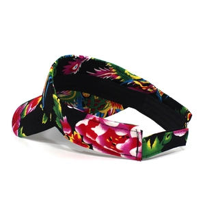 Detail view of colorful floral pattern on a sun visor hat with adjustable back strap