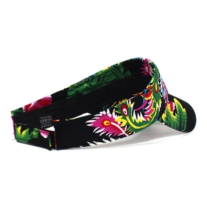 Detail view of cotton sun visor with floral pattern showing adjustable velcro strap