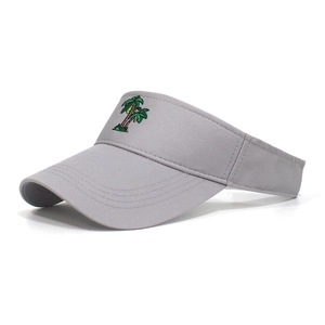 Detailed close-up of green coconut tree embroidery on a grey cotton sun visor hat