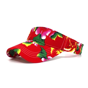 Detail of floral pattern sun visor hat with wide brim and adjustable strap