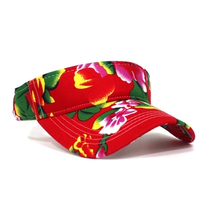 Detail of red floral print sun visor with tropical patterns and reinforced stitching