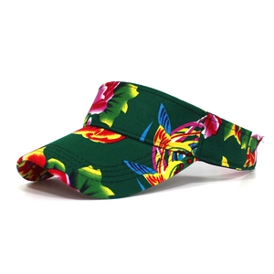 Detailed close-up of dark green sun visor with vibrant pink floral and tropical bird print