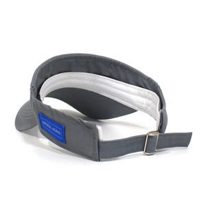 Detail view of adjustable metal buckle and blue woven label on a grey cotton visor