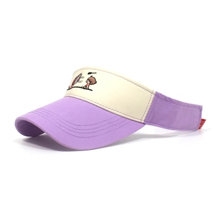Detail of embroidered cartoon character on purple and beige patchwork sun visor hat