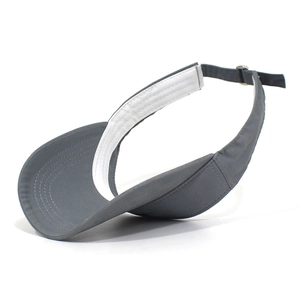 Detail view of dark grey sun visor featuring cotton twill texture and adjustable metal buckle