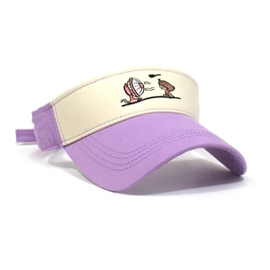 Detail of cute cartoon girl embroidery on a purple and beige cotton sun visor hat
