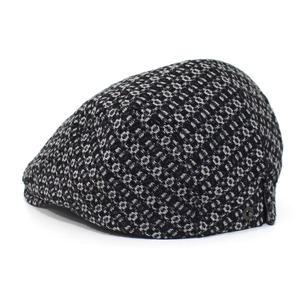 Detailed view of jacquard denim fabric texture and vintage button on a flat cap
