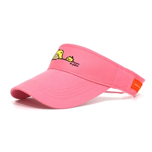 Detail of pink cotton sun visor featuring cartoon girl embroidery and an orange side tag