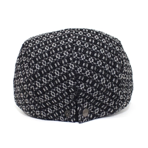 Detailed view of the textured jacquard cotton fabric and metal buckle on the flat cap