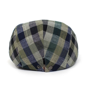 Detail shot of the back of a green plaid ivy cap featuring an adjustable metal buckle