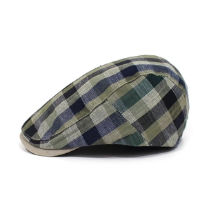 Detailed side view of a vintage plaid flat cap with contrasting cotton khaki visor brim