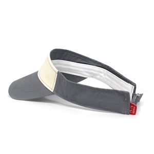 Detail view of cotton sun visor hat with contrast stitching and adjustable buckle