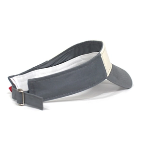 Detail view of adjustable metal buckle and beige-grey cotton panels on the sun visor hat