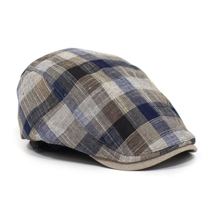 Detailed view of breathable cotton plaid ivy cap texture in blue and beige tones