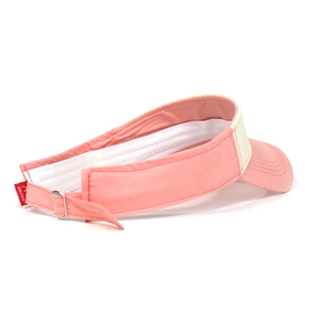 Detail of adjustable strap and red brand tag on a pink and beige sun visor hat
